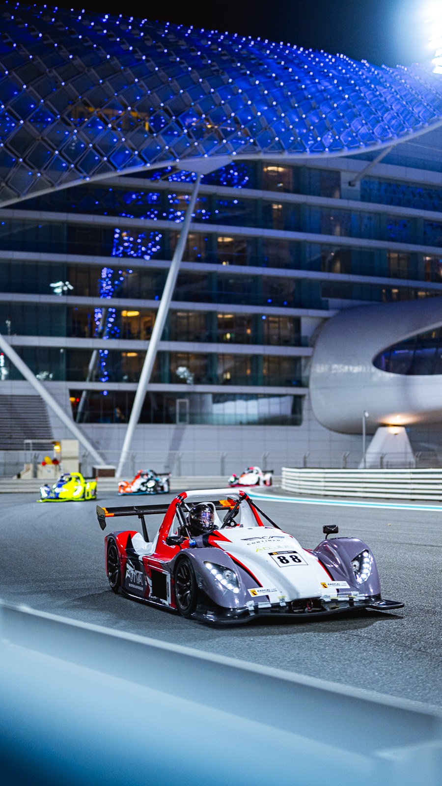 The team’s Radical SR3, number 88, at night under the Yas Marina hotel.