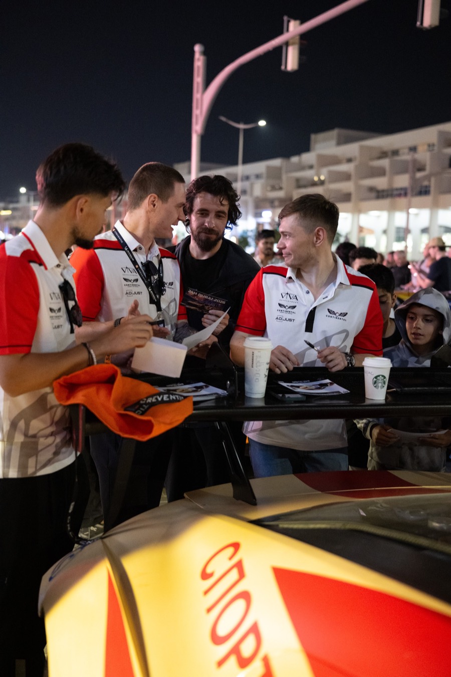 The drivers signing cards for the crowd at the night pit walk