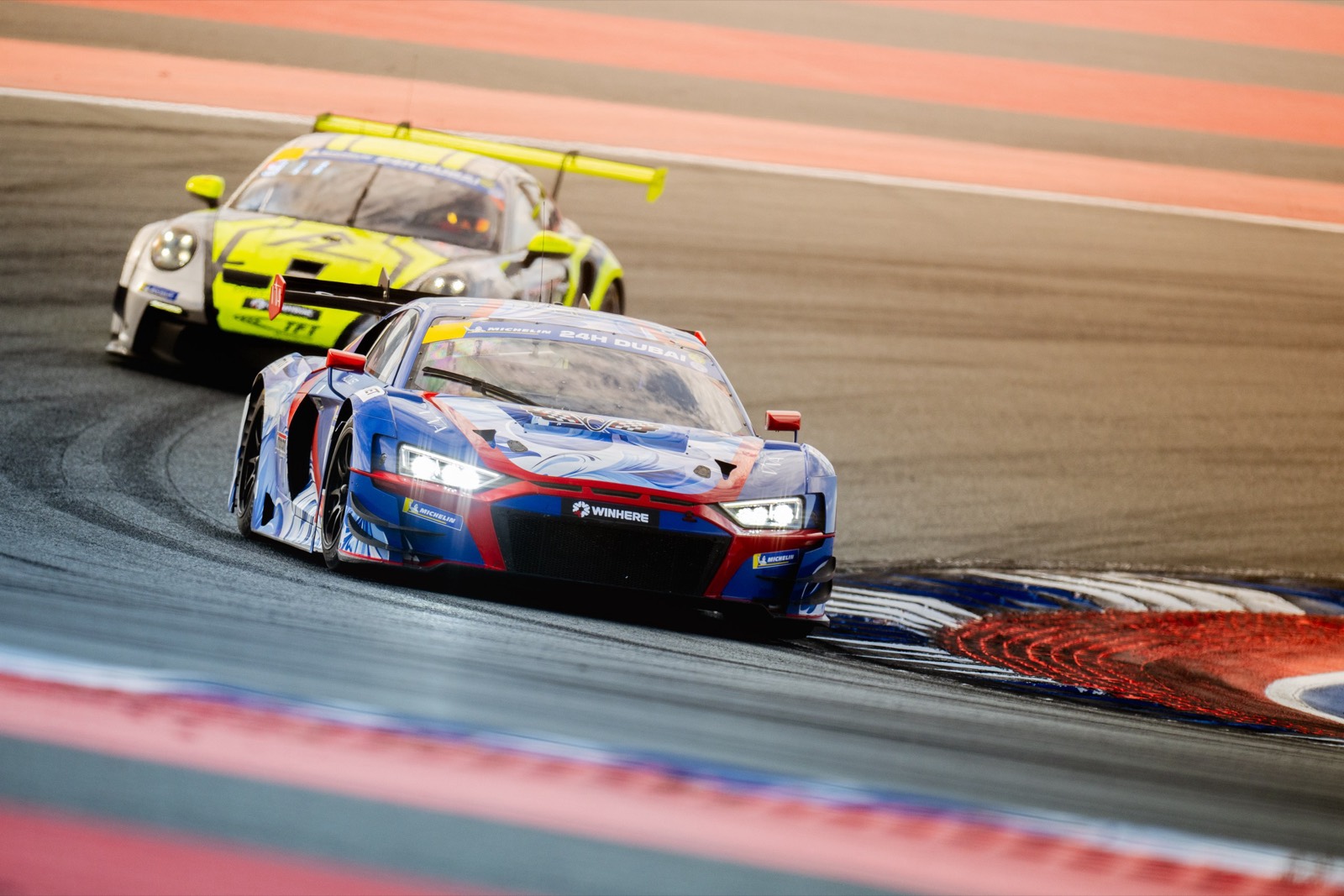 The team’s Audi R8 LMS GT3 leading a Porsche through a corner at the Dubai 24 Hours, 2025.